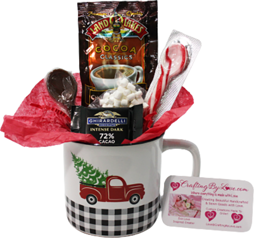 Gift cup featuring red truck with christmas tree in back filled with Cocoa, marshmellows, chocolate spoon and peppermint spoon, with chocolate candy.